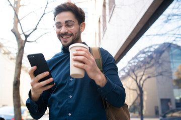 Young man using his mobile phone outdoors.