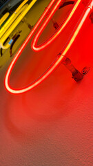 Multi color office clip shaped neon lights installed on white wall