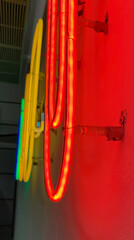 Multi color office clip shaped neon lights installed on white wall