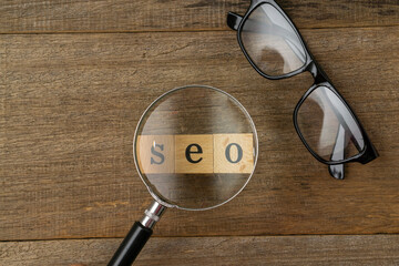 SEO, Search Engine Optimization ranking concept on magnifying glass. 