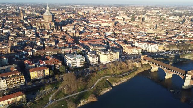 Drone view of the medieval city of Pavia in Italy : flyng over Ticino river and Old Town