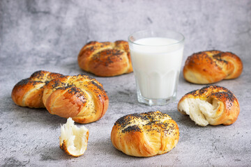 Sweet buns with poppy seeds served with milk.