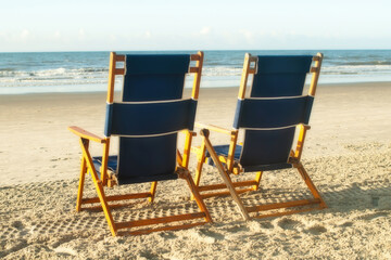 two empty beach chairs awaiting guests