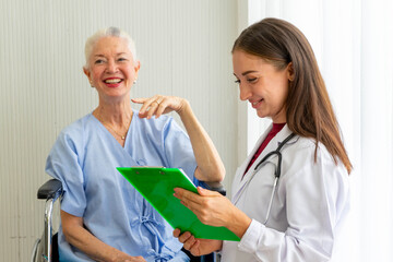 Caucasian old senior depressed upset woman patient on wheelchair talking to medical doctor with stethoscope  in hospital 