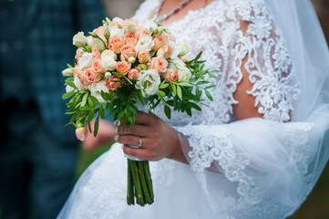 Bouquet of flowers in the hand of the bride