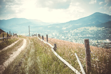 Fototapeta na wymiar dirt road on a background of mountains