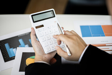 The company's finance manager is using a calculator.