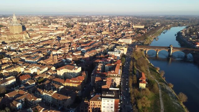 Drone view of the medieval city of Pavia in Italy : flyng over Ticino river and Old Town