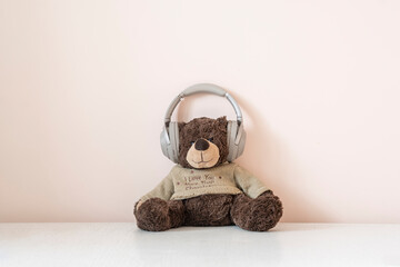 teddy bear in headphones listen to the audio music radio