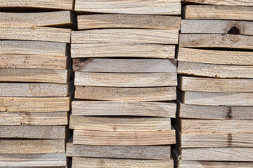 Lumber. sawn boards lie in group. Many different rectangular wooden blocks are stacked on top of each other. Wooden background, texture. Building materials in store.
