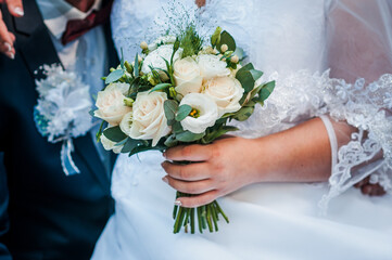 Bouquet of flowers in the hand of the bride