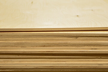 Lumber. Plywood sheets lie in group. Many different rectangular wooden blocks are stacked on top of each other. Wooden background, texture. Building materials in store. Space for text