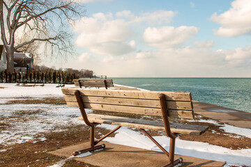 Fototapeta na wymiar a bench overlooking lake ontario in the community of Niagara on the Lake 