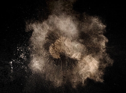 Dust explosion isolated on black background, close up