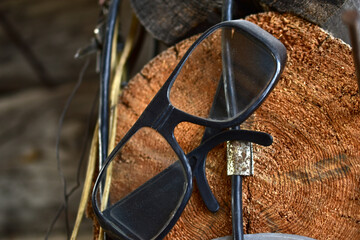 Fototapeta na wymiar Joiner's glasses Carpenter's sunglasses on a hook in the garage