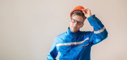 young male worker holding a helmet, industrial safety equipment