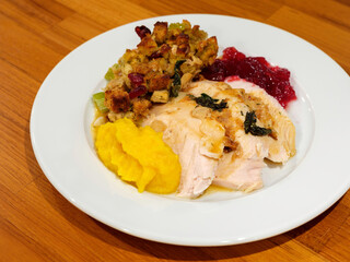 Thanksgiving dinner plate with turkey, gravy, stuffing, cranberry sauce, and butternut squash puree