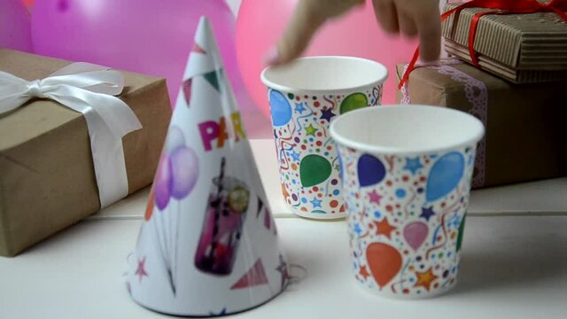 Childrens birthday. Table decorations, balloons, treats, juice and gifts. A lot of colorful balloons prepared for a childs birthday party that will surely end up exploding. Synonym of fun and joy.