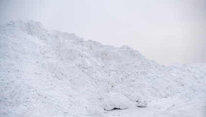 large pile of snow in the street near road, winter season