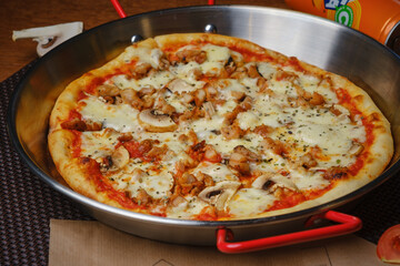 Delicious hearty pizza lies on the table