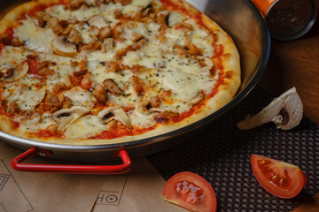 Delicious hearty pizza lies on the table