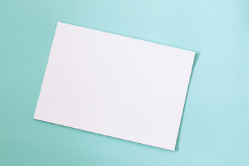 blank paper mock up on mint green background