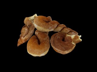 three twisted buns on a black background