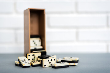 Box with retro dominoes on table
