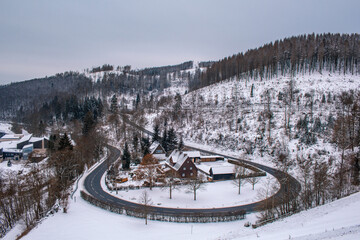 Obraz premium Winter in Harz Mountains National Park, Germany. Curved road and snow covered landscape