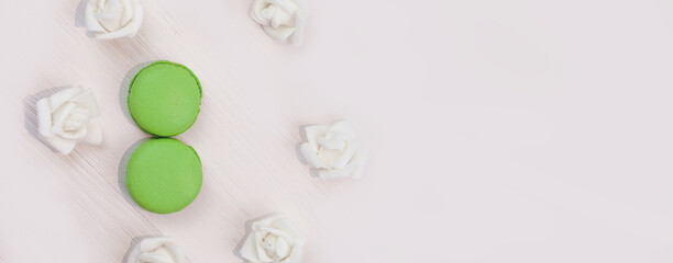8 March macaroons on wooden background. Spring concept, International Womens Day celebrate, copy space. Banner.