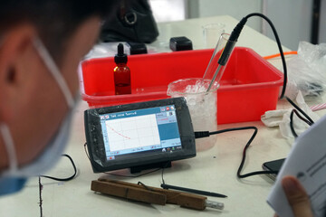 A blur of researchers looking at a chemical experiment display. Modern science experimental...