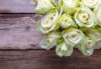 White roses on the wooden background.  Wedding bouquet concept.
