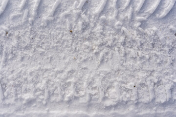 car tire footprint on the snow left