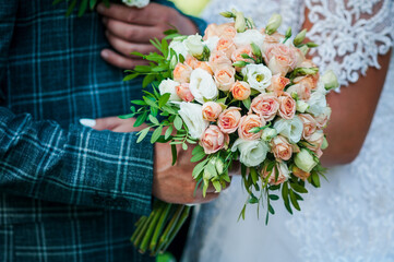 Bouquet of flowers in the groom's hand