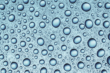 Rain on window. Water bubbles texture. Round shapes pattern. Blue water backdrop. Wet glass background.