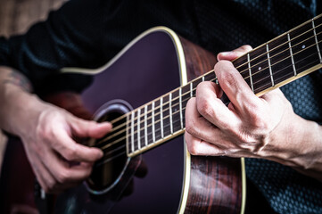 Fototapeta na wymiar man playing an acoustic guitar