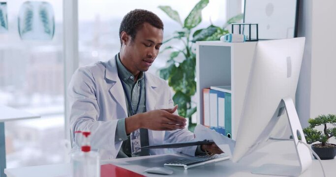 Handsome African American General Practitioner Doctor Videochatting with Customer Online Talking to Patient Diagnisus Explaining Healthcare Treatment.