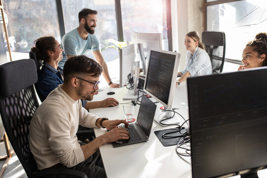 Group of designers programmers working on a new project at the office.	
