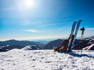 Ski mountaineer relaxing on the top of a mountain