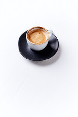 Cup of coffee on bright wooden background. Copy space.