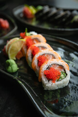 Sushi roll with salmon and caviar, close-up