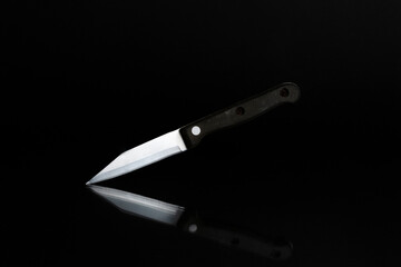 Knife on a black background with reflection for product illustration
