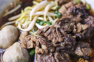 Thai boat noodles is Thailand's most famous noodles soup,Thai Boat noodles soup or Guay tiew reua ,Rice noodles thicken soup with stewed pork and pork ball, Braised pork and liver pork, 
