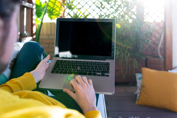 Unrecognizable man with a laptop with black screen