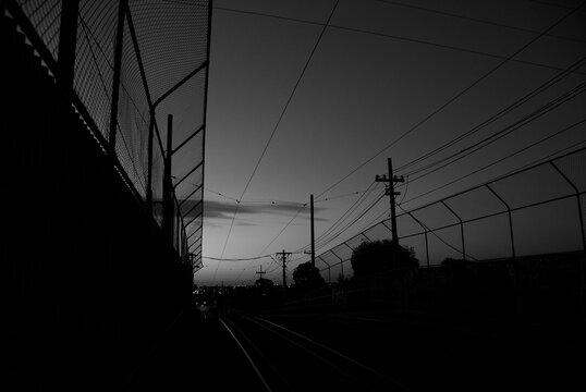 Tram Tracks And Power Lines Silhouetted At Dusk In The Melbourne Suburb Of Preston, Australia.