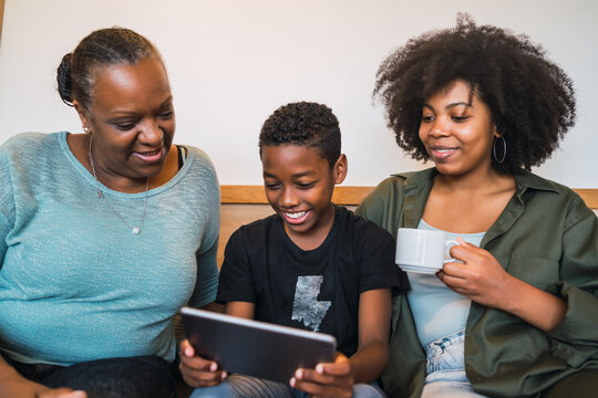 Grandmother, mother and son using digital tablet.