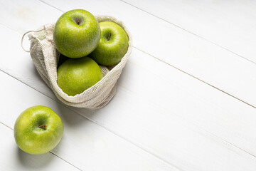 Fresh green apples in an eco-friendly fruit bag