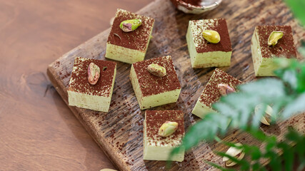 Handmade souffle candy with pistachioon a wooden background. Homemade sweets or candies. Pistachio souffle.