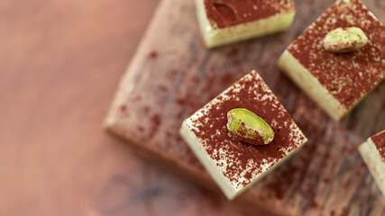 Handmade souffle candy with pistachioon a wooden background. Homemade sweets or candies. Pistachio souffle.