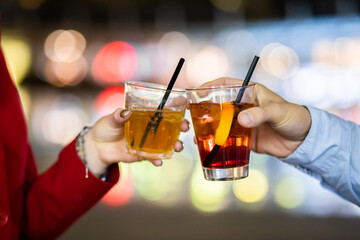 Friends toasting glasses in a disco